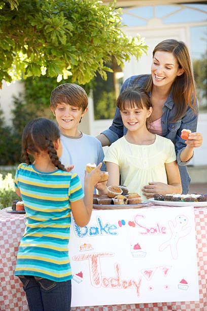 Kids selling cookies at bake sale