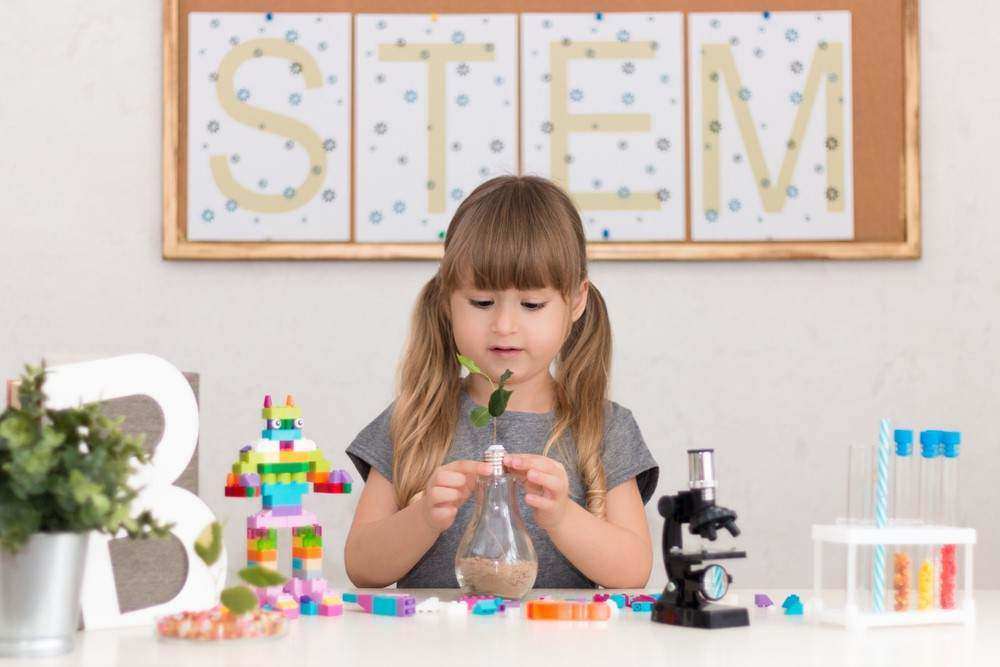 little girl creating STEM project